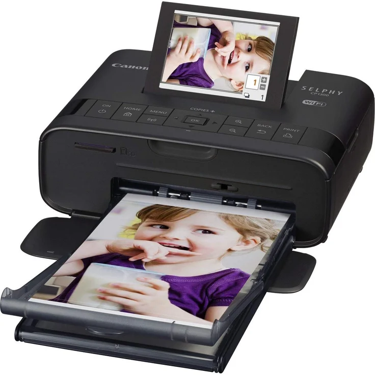 Canon Selphy CP1300 Fotodrucker 10x15cm (mobil Drucker, WLAN,USB,300x300dpi, Thermosublimation, optionaler Akku, Farbdisplay, Speicherkartenslot, Apple AirPrint, Passfoto- u. Postkartendruck) schwarz (2234C002) – Bild 1